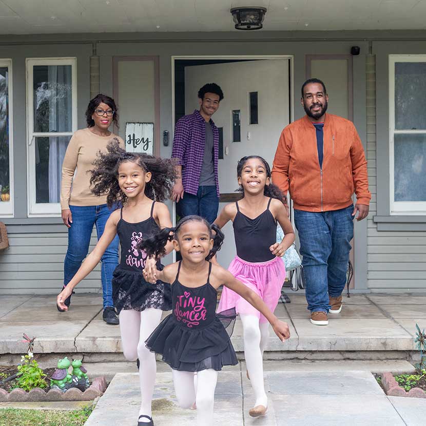 A family outside their home uses the Behavioral Finance Advice program to help make more intentional investment choices.