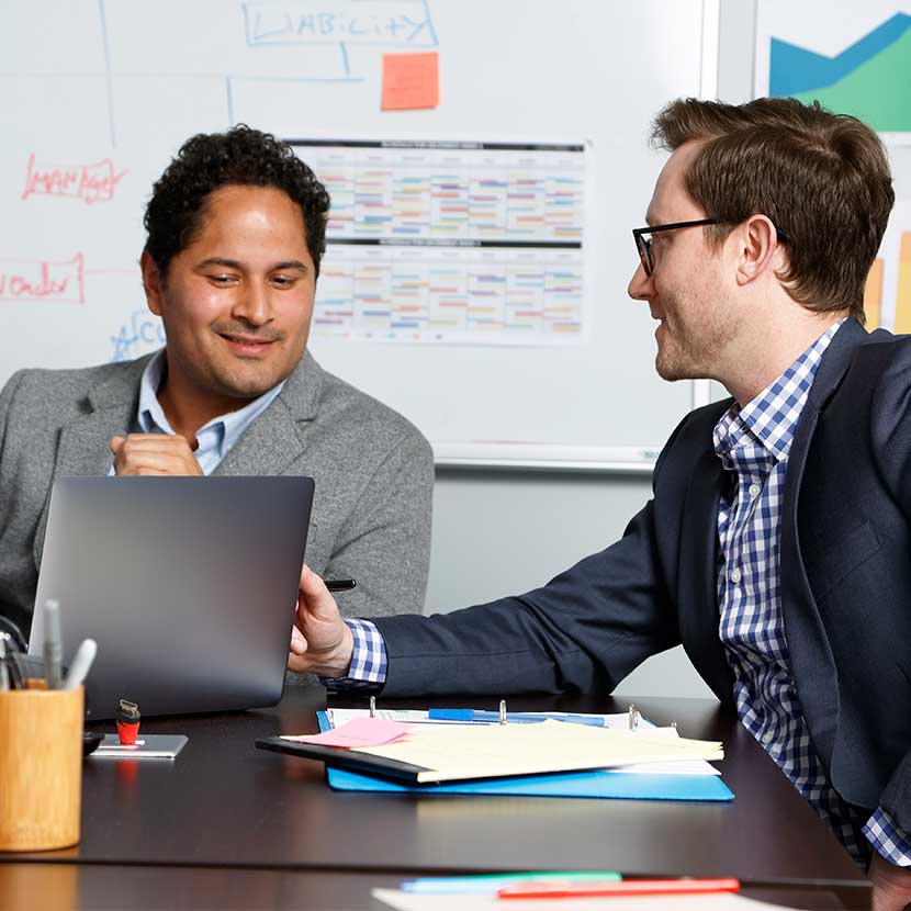 A financial professional in office with a client discussing TruStage™ retirement products.
