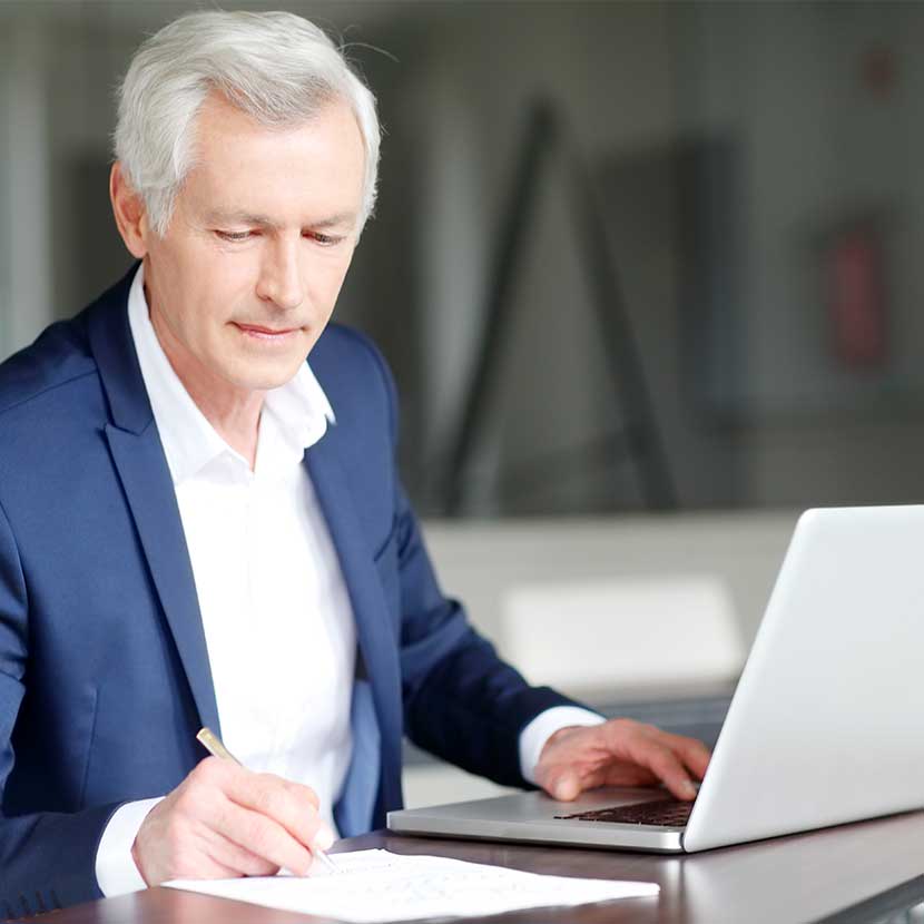 A financial professional reads TruStage annuities blog on his laptop to help grow his business
