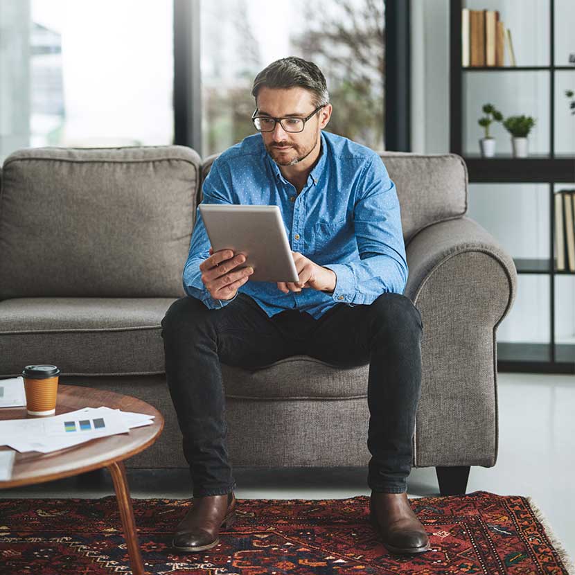 Man looking at the computer displaying information about TruStage Annuities