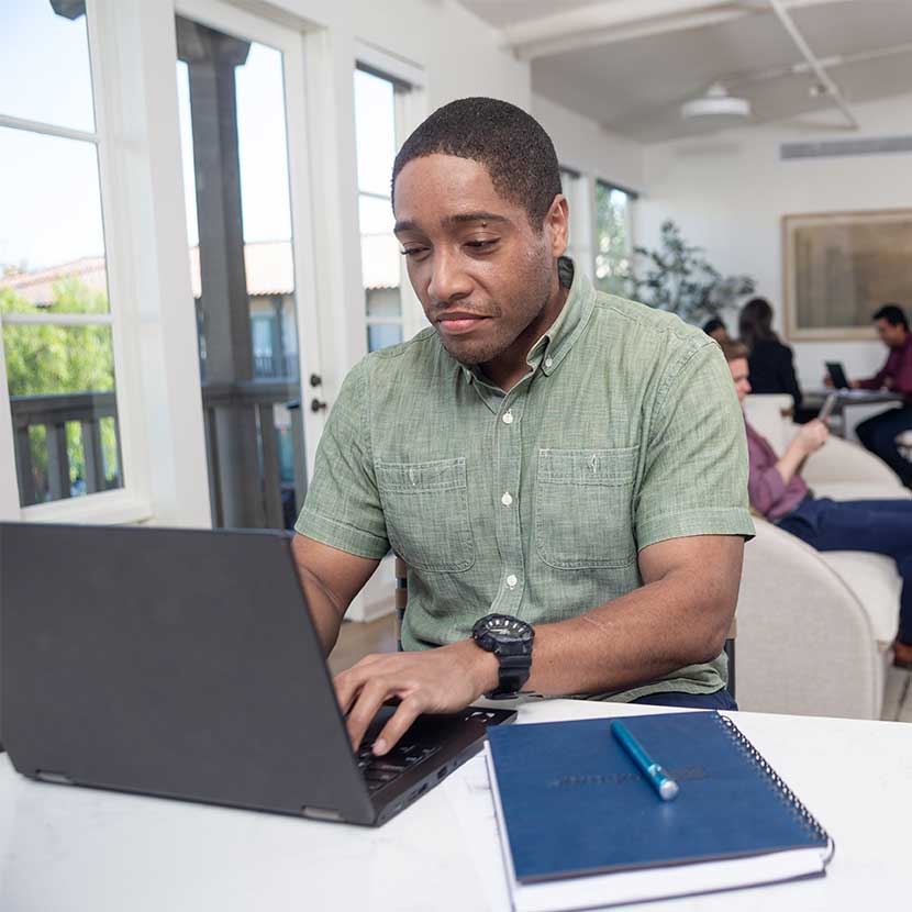A financial professional reviews TruStage™ annuities webinars on his laptop to learn how to attract, retain, and grow clients.