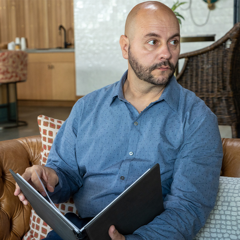 Man holding portfolio looking away