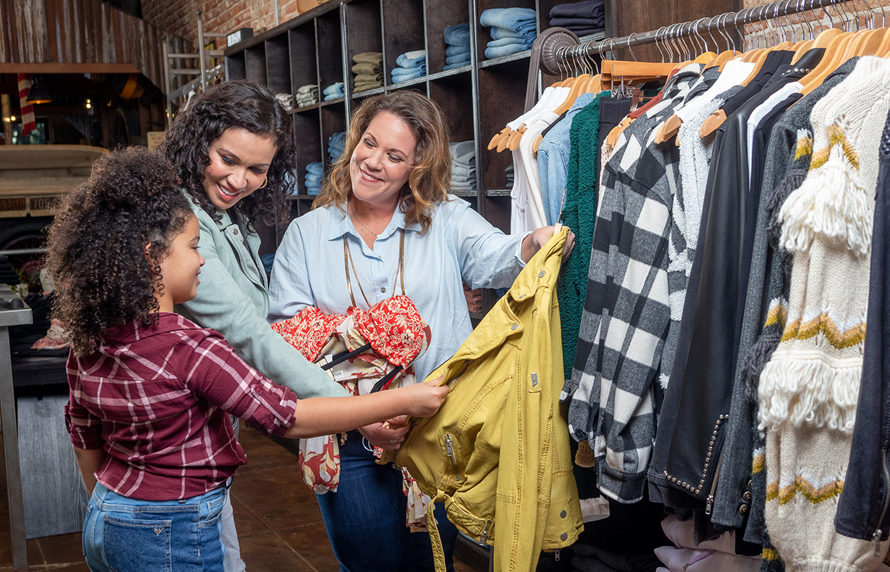 A family shopping for clothes and talking about TruStage
