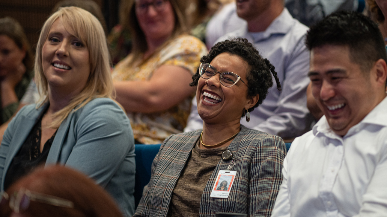 Employees laughing during a seminar