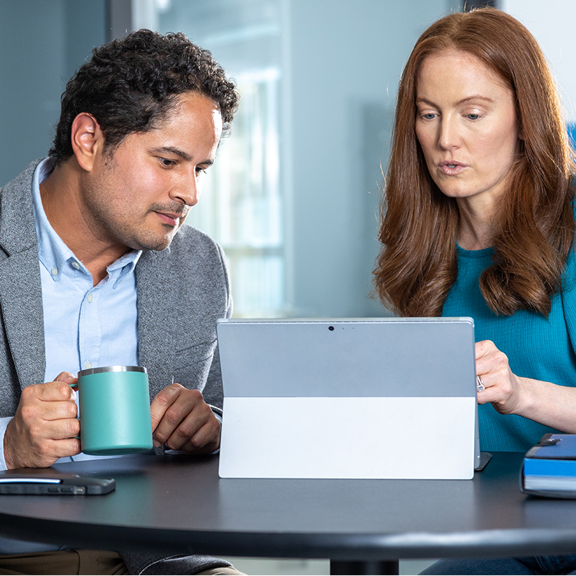 Coworkers looking at laptop