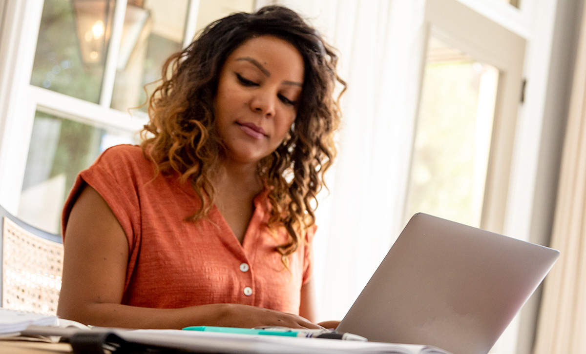 Woman with laptop checks her MEMBERS® Future Income Annuity - it uses the power of deferral to help maximize guaranteed future income.