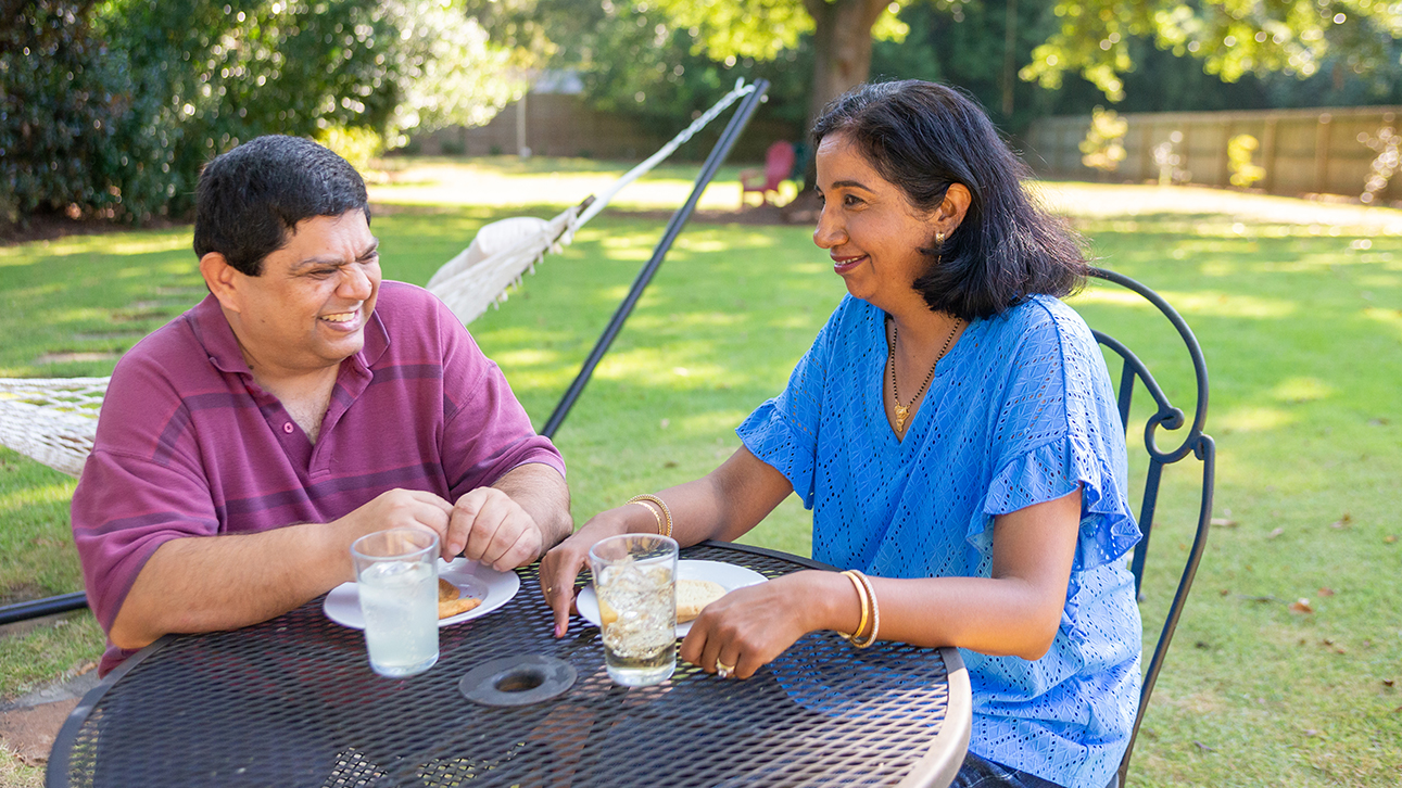 A man talking to a woman about how happy he is to learn about future income annuity investments