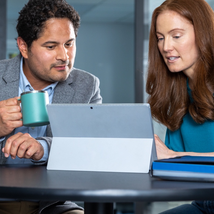 A couple uses their laptop to research insurance terms and definitions