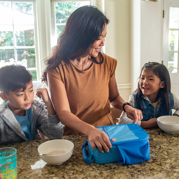 Mother and her two children talking at the kitchen table