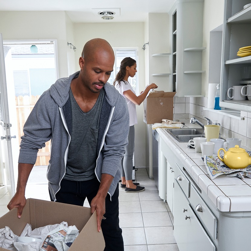 A man unpacking boxes in his kitchen