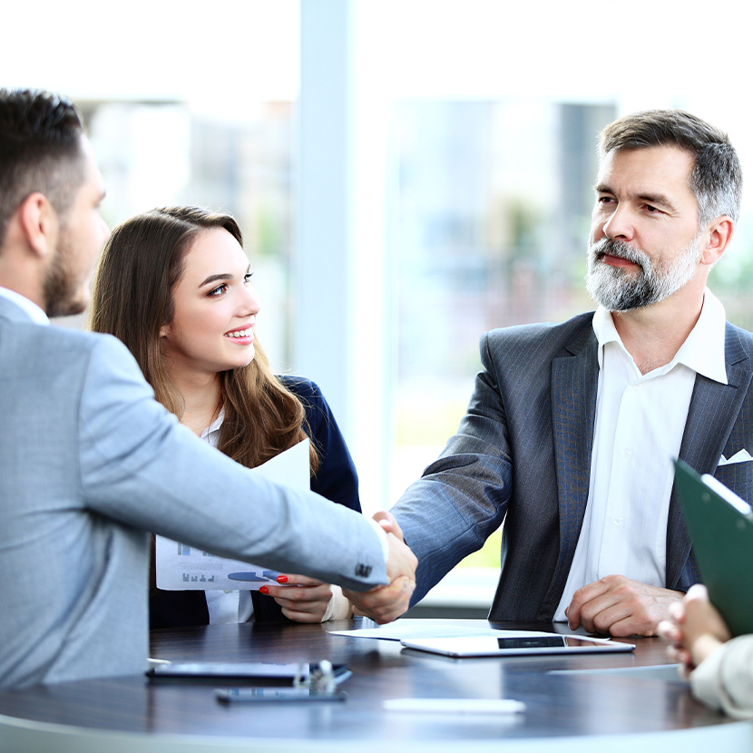 Man, woman and man meeting and shaking hands