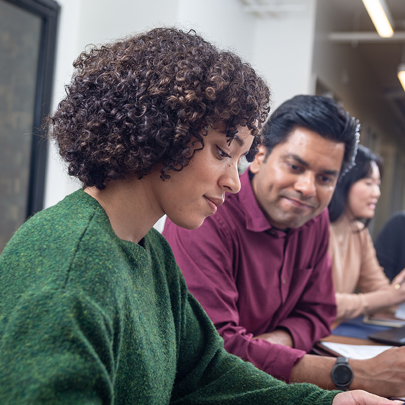 Woman reviewing work with man